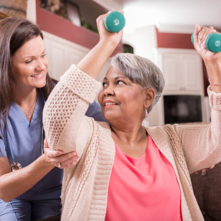 Caregiver Assisting Client with Light Exercise